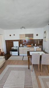 a kitchen and living room with a table and chairs at Apartman Marija in Zlatibor +41 photos