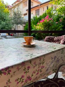 a coffee cup sitting on a table with a table cloth at Villa Vera in Vrnjačka Banja