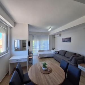 a living room with a couch and a table at Apartments Lakeside Elesec in Ohrid