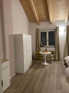 a living room with a table and a dining room at Bed and Breakfast Casa Tortia in Cocconato