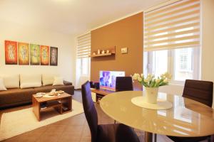 a living room with a table and a couch at Allegro Exclusive Suites Old Town Center in Zadar