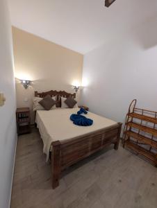a bedroom with a bed with a blue towel on it at Thamani Apartment Zanzibar in Pwani Mchangani