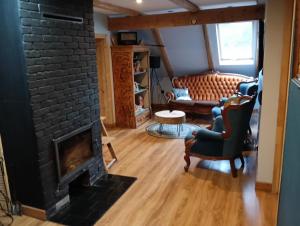 a living room with a black brick fireplace at Agroturystyka Janowa Chata in Krajanow