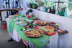 a table topped with a buffet of food and bread at Alte Kalkoefen Lodge in Simplon