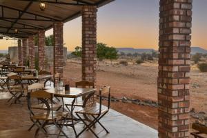 a restaurant with tables and chairs in the desert at Alte Kalkoefen Lodge in Simplon +33 photos