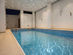 a swimming pool with blue water in a building at The Hills in Accra