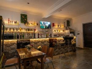 a bar with a counter and a table and chairs at The Hills in Accra