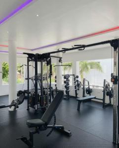 a gym with a lot of tread machines in it at The Hills in Accra