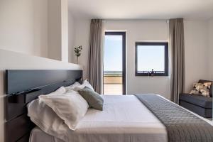 a bedroom with a large white bed with pillows at Feudo Antico in Tollo