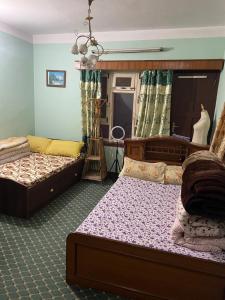 a bedroom with two beds and a mirror at Patan Nest in Pātan
