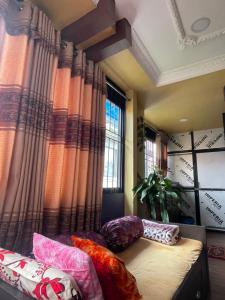 a room with curtains and a bed with pillows at Patan Nest in Pātan