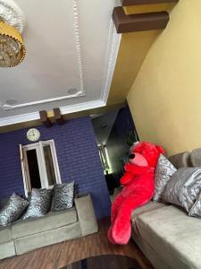 a red teddy bear sitting on a couch in a room at Patan Nest in Pātan