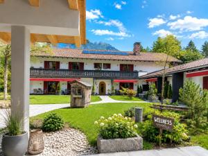 a view of the inn from the courtyard at Bayern Resort Hotel - Adults only - mit Zugspitzblick - Eibsee-Nähe - Wellnessbereich - Naturpool im Sommer in Grainau