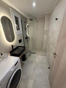 a bathroom with a shower and a sink and a toilet at HOME stay in Itea