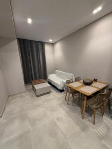 a dining room with a table and a bed at HOME stay in Itea +3 photos