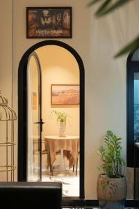 an archway leading to a table with a vase at Homestay Beauty D1 in Ho Chi Minh City