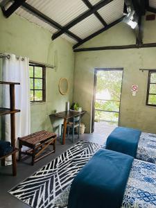 a bedroom with a bed and a table and a window at Emoyeni Eco Lodge in Sodwana Bay +89 photos