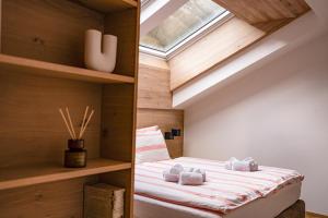 a bedroom with a bed in a room with a window at central sky-penthouse with iconic matterhorn view in Zermatt
