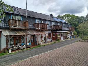 an old house with wooden balconies on a street at Pokoje Gościnne Poniatowscy in Świeradów-Zdrój
