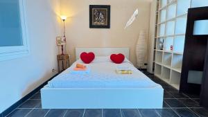 a bedroom with a bed with two hearts on it at I mille Tramonti di Ilaria in Livorno