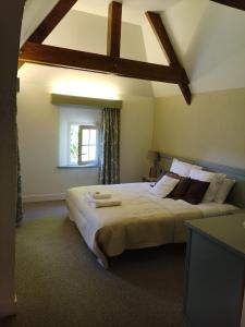 a bedroom with a large bed and a window at Le Green de Bellême in Bellême