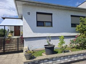 a white house with the number on it at Apartment Anna - Austrian country house in Marchfeld im Weinviertel in Marchegg