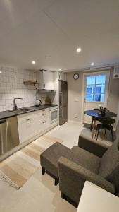 a kitchen and living room with a couch and a table at Spacious villa in Sörby in Gävle