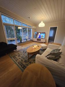 a living room with a couch and a table at Spacious villa in Sörby in Gävle