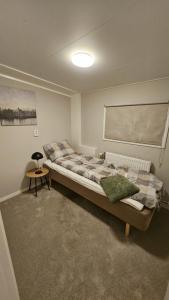 a bedroom with a bed with a table in it at Spacious villa in Sörby in Gävle