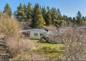 a house on a hill with trees in the background at Spacious villa in Sörby in Gävle