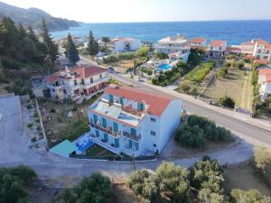 an aerial view of a house with the ocean at Dina Apartments Kokkari, Pension Dina, Dina Rooms in Kokkari