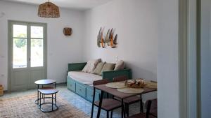 a living room with a couch and a table at Firogia Olive Grove Hideaway in Sifnos