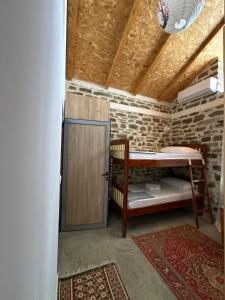 a room with a door in a brick wall at Stone House in Këlcyrë +24 photos