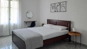 a bedroom with a large bed and a chair at Firogia Olive Grove Hideaway in Sifnos