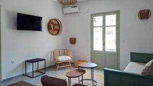 a living room with a couch and a chair at Firogia Olive Grove Hideaway in Sifnos