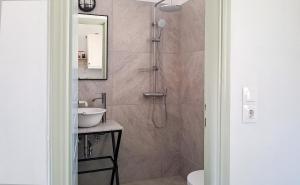a bathroom with a shower and a sink at Firogia Olive Grove Hideaway in Sifnos +20 photos