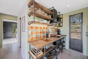 a kitchen with a sink and a counter at Dundalli Lodge in Conondale