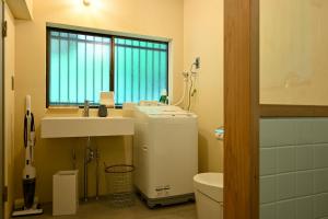 a bathroom with a sink and a toilet and a window at Beppu TOJIHAUS 002 Hilltop Sea View 8min walk to Hells of Beppu in Beppu +61 photos