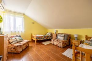a living room with two couches and a window at Boka Garden in Bijela