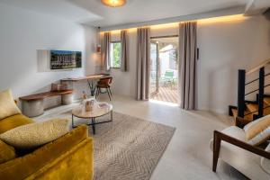 a living room with a couch and a table at Hôtel du Parc Cavalaire sur Mer in Cavalaire-sur-Mer