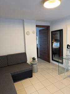 a living room with a couch and a bedroom at Ktima Papaoikonomou in Potos