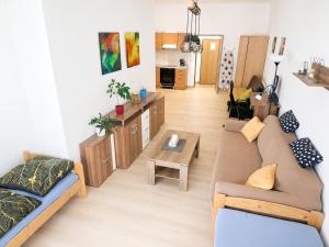 a living room with a couch and a table at Apartmany 123 in Broumov +18 photos