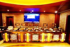a table in a room with a stage withktop at HOTEL EXCELLENCY in Bhubaneshwar