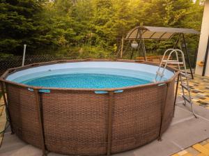 a hot tub in a wicker enclosure on a patio at Апарт Стефанія in Skhidnitsa