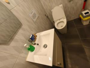 a bathroom with a white sink and a toilet at Mays Hostel in Hua Hin +20 photos