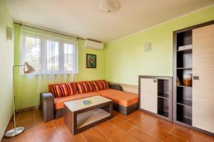 a living room with a couch and a table at Boka Garden in Bijela