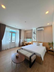 a large bedroom with a bed and a table at Hue Glow Homestay in Thôn Lại Thê