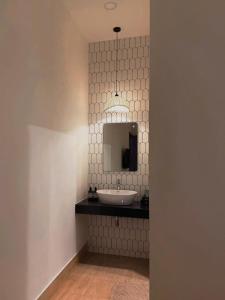 a bathroom with a sink and a mirror at Hue Glow Homestay in Thôn Lại Thê +16 photos