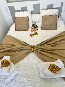 a white bed with blankets and towels on it at Lady laying in Le Diamant +50 photos