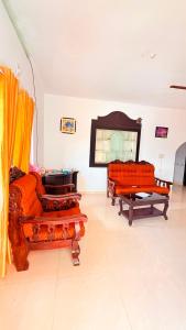 a living room with two couches in a room at Winter Flys in Anaviratty